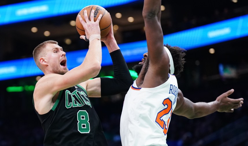 Boston Celtics center Kristaps Porzingis (8) shoots against New York Knicks center Mitchell Robinson (23) in the first quarter at TD Garden