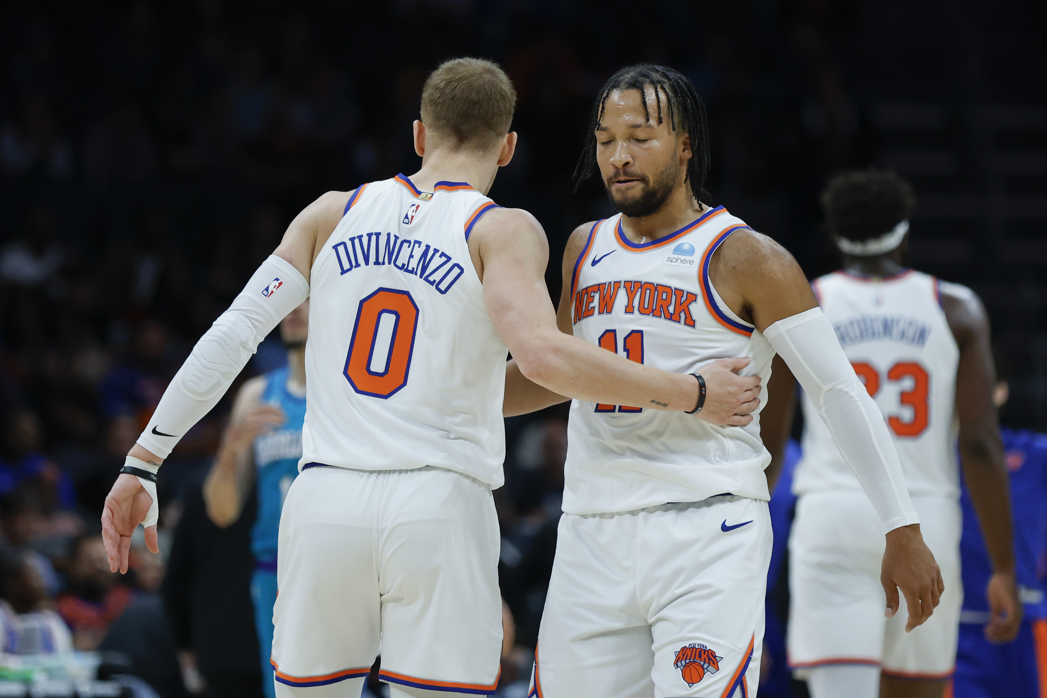 New York Knicks guard Jalen Brunson (11) embraces guard Donte DiVincenzo (0) during the first quarter against the Charlotte Hornets at Spectrum Center