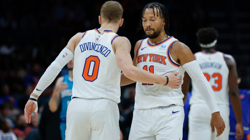 New York Knicks guard Jalen Brunson (11) embraces guard Donte DiVincenzo (0) during the first quarter against the Charlotte Hornets at Spectrum Center