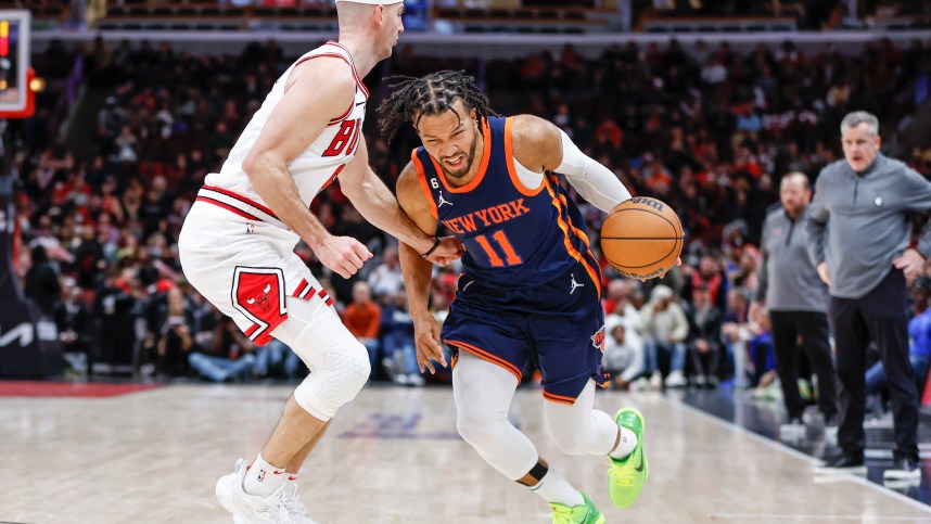 New York Knicks guard Jalen Brunson (11) drives to the basket against Chicago Bulls guard Alex Caruso (6) during overtime at United Center