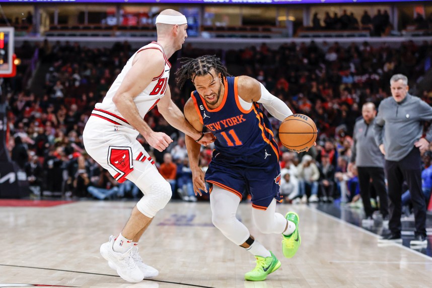 New York Knicks guard Jalen Brunson (11) drives to the basket against Chicago Bulls guard Alex Caruso (6) during overtime at United Center