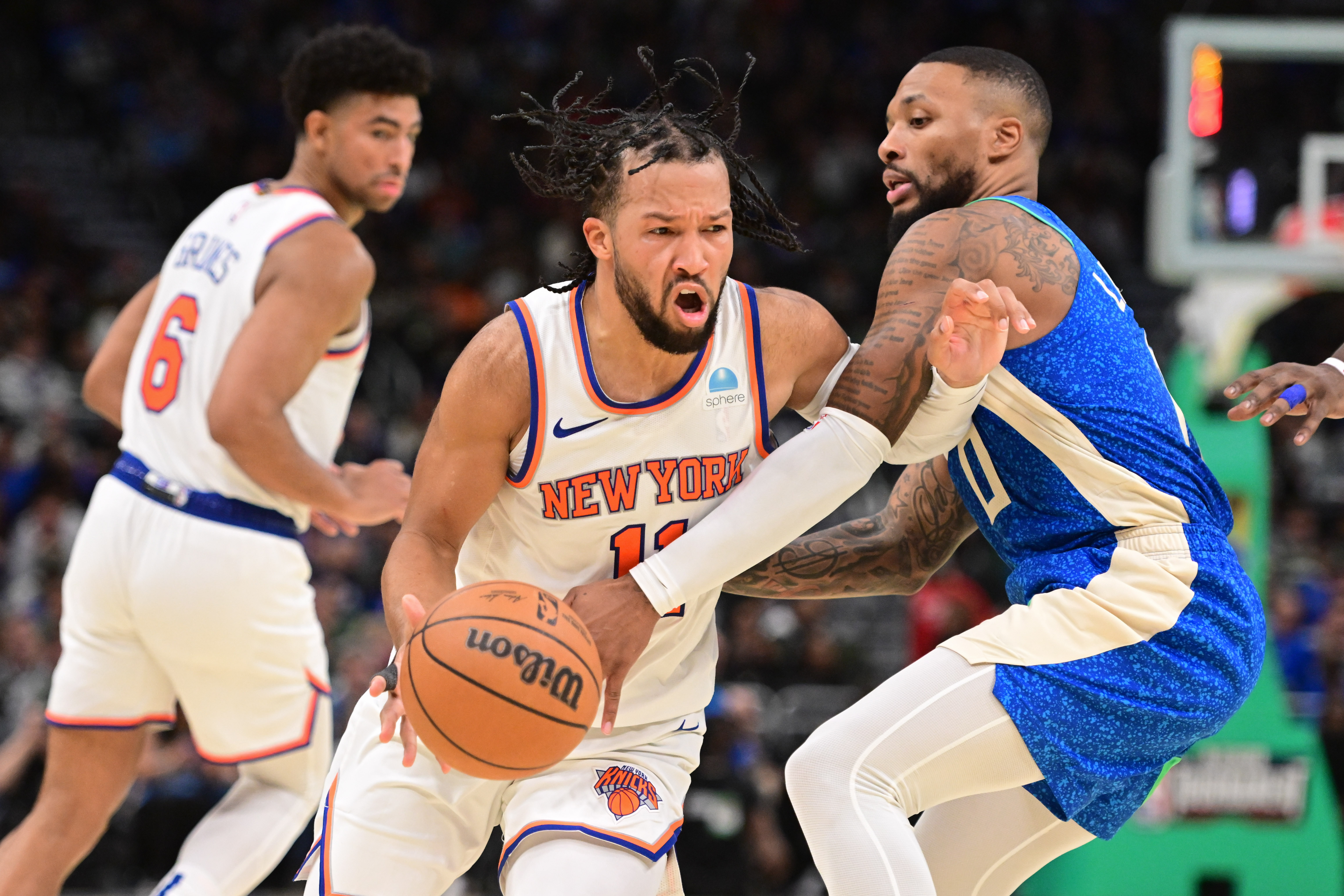 New York Knicks guard Jalen Brunson (11) drives for the basket against Milwaukee Bucks guard Damian Lillard (0) in the fourth quarter at Fiserv Forum