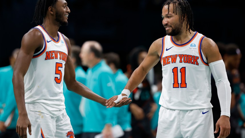 New York Knicks guard Immanuel Quickley (5) celebrates with Knicks guard Jalen Brunson (11) against the Washington Wizards in the fourth quarter at Capital One Arena
