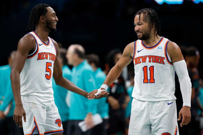 New York Knicks guard Immanuel Quickley (5) celebrates with Knicks guard Jalen Brunson (11) against the Washington Wizards in the fourth quarter at Capital One Arena
