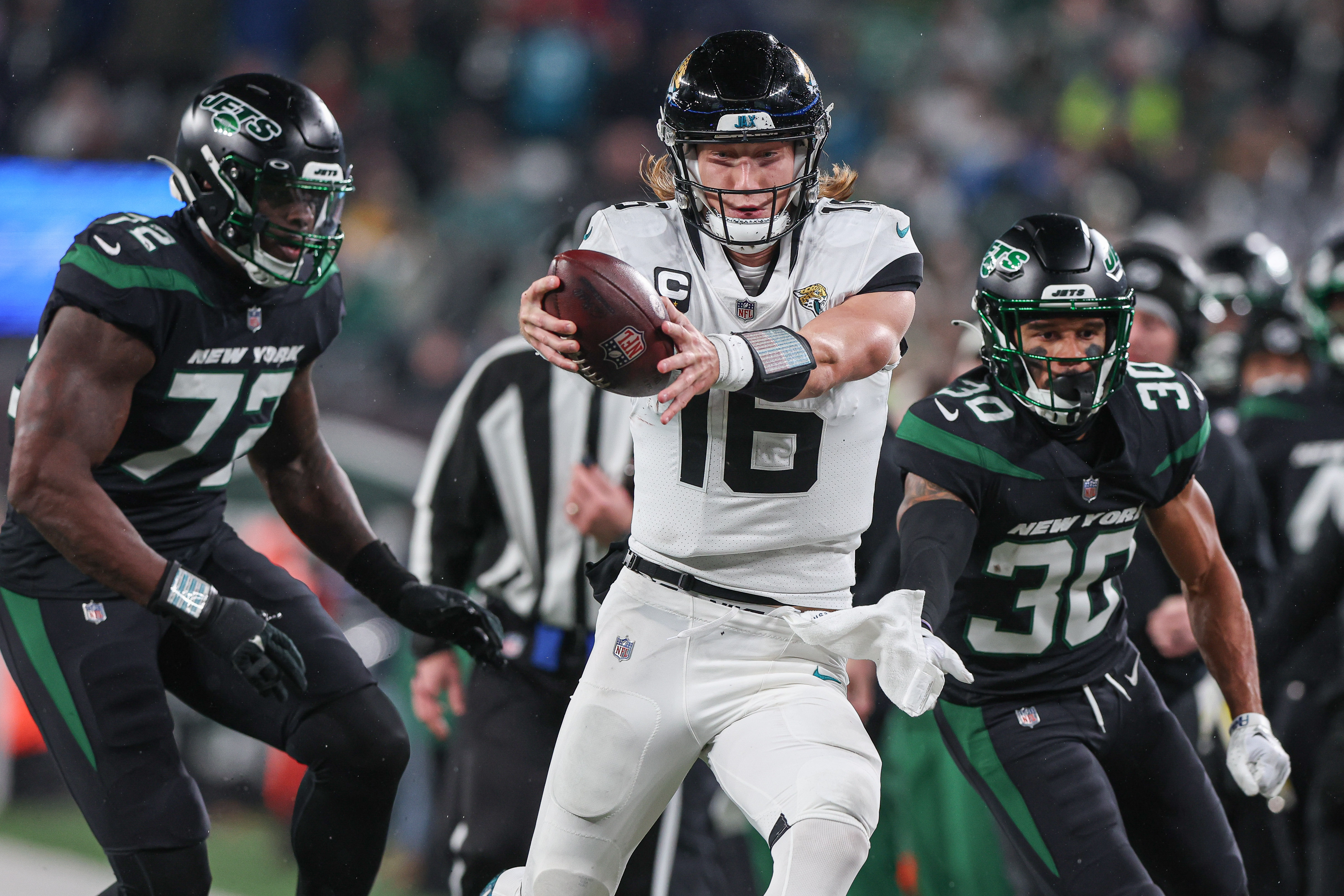 New York Jets wide receiver Jeff Smith (16) reaches for extra yards in front of New York Jets defensive end Micheal Clemons (72) and cornerback Michael Carter II (30) during the first half at MetLife Stadium