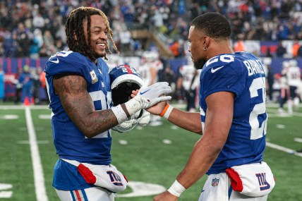 New York Giants safety Xavier McKinney (29) celebrates with running back Saquon Barkley (26) after a New England Patriots missed field goal during the fourth quarter at MetLife Stadium