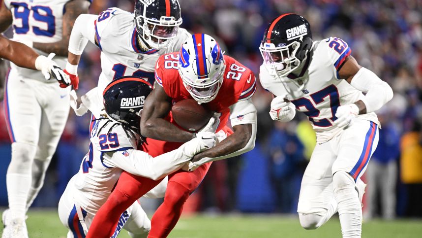 Buffalo Bills running back Latavius Murray (28) is tackled by New York Giants safety Xavier McKinney (29) and safety Jason Pinnock (27) in the second quarter at Highmark Stadium