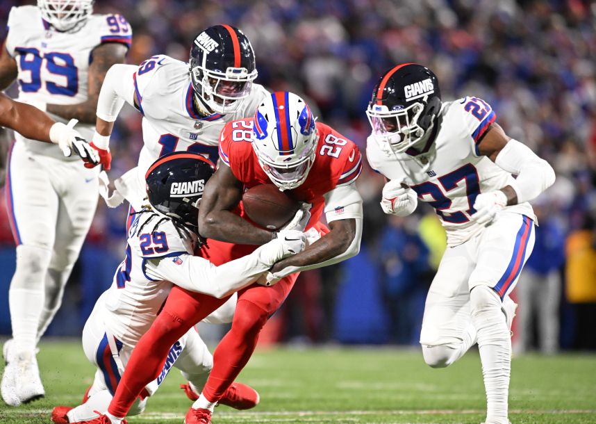 Buffalo Bills running back Latavius Murray (28) is tackled by New York Giants safety Xavier McKinney (29) and safety Jason Pinnock (27) in the second quarter at Highmark Stadium