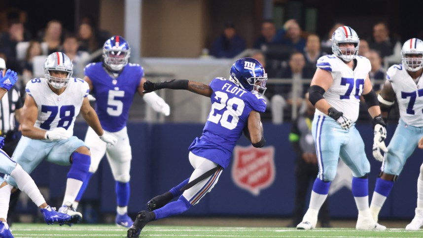 New York Giants cornerback Cor'Dale Flott (28) runs with the ball after making an interception in the first quarter against the Dallas Cowboys at AT&T Stadium