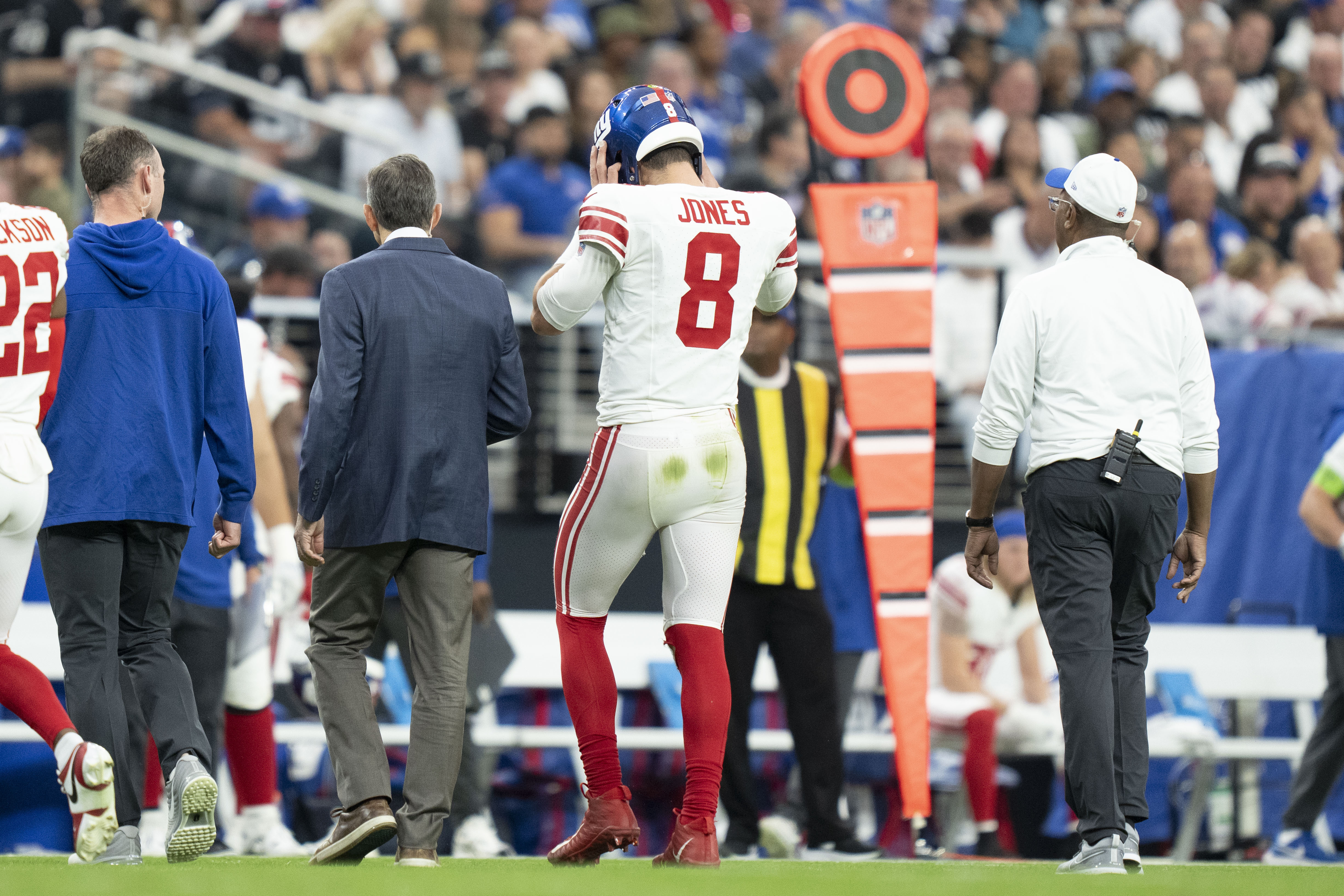 New York Giants quarterback Daniel Jones (8) walks to the sideline after an injury against the Las Vegas Raiders during the second quarter at Allegiant Stadium