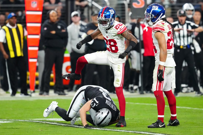 New York Giants cornerback Cor'Dale Flott (28) celebrates after breaking up a reception attempt by Las Vegas Raiders wide receiver Hunter Renfrow (13) during the fourth quarter at Allegiant Stadium
