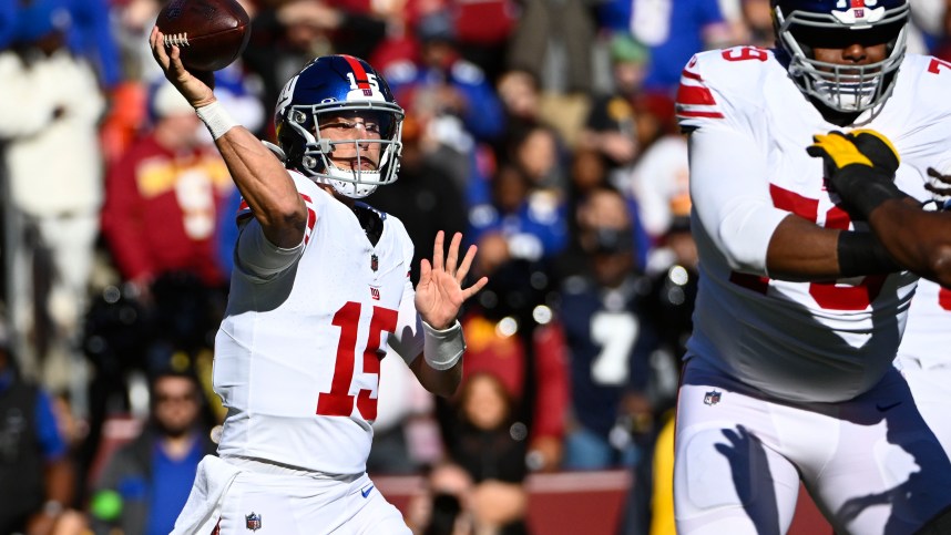 New York Giants quarterback Tommy DeVito (15) attempts a pass against the Washington Commanders during the first half at FedExField