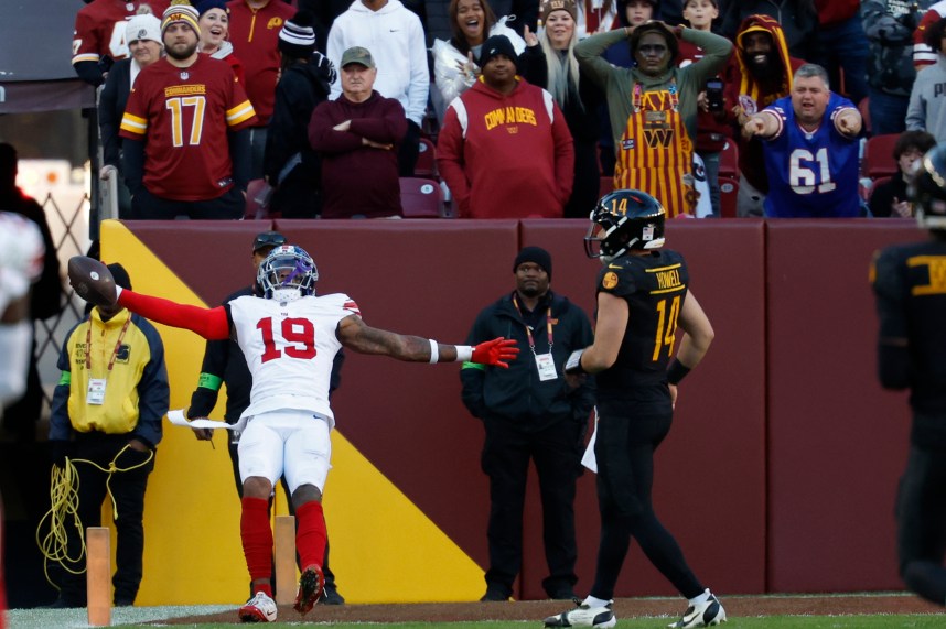New York Giants safety Isaiah Simmons (19) celebrates while scoring a touchdown on an interception of Washington Commanders quarterback Sam Howell (14) in the final minute during the fourth quarter at FedExField