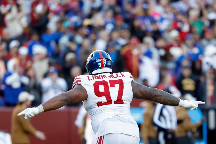 New York Giants defensive tackle Dexter Lawrence II (97) celebrates after an interception against the Washington Commanders during the fourth quarter at FedExField