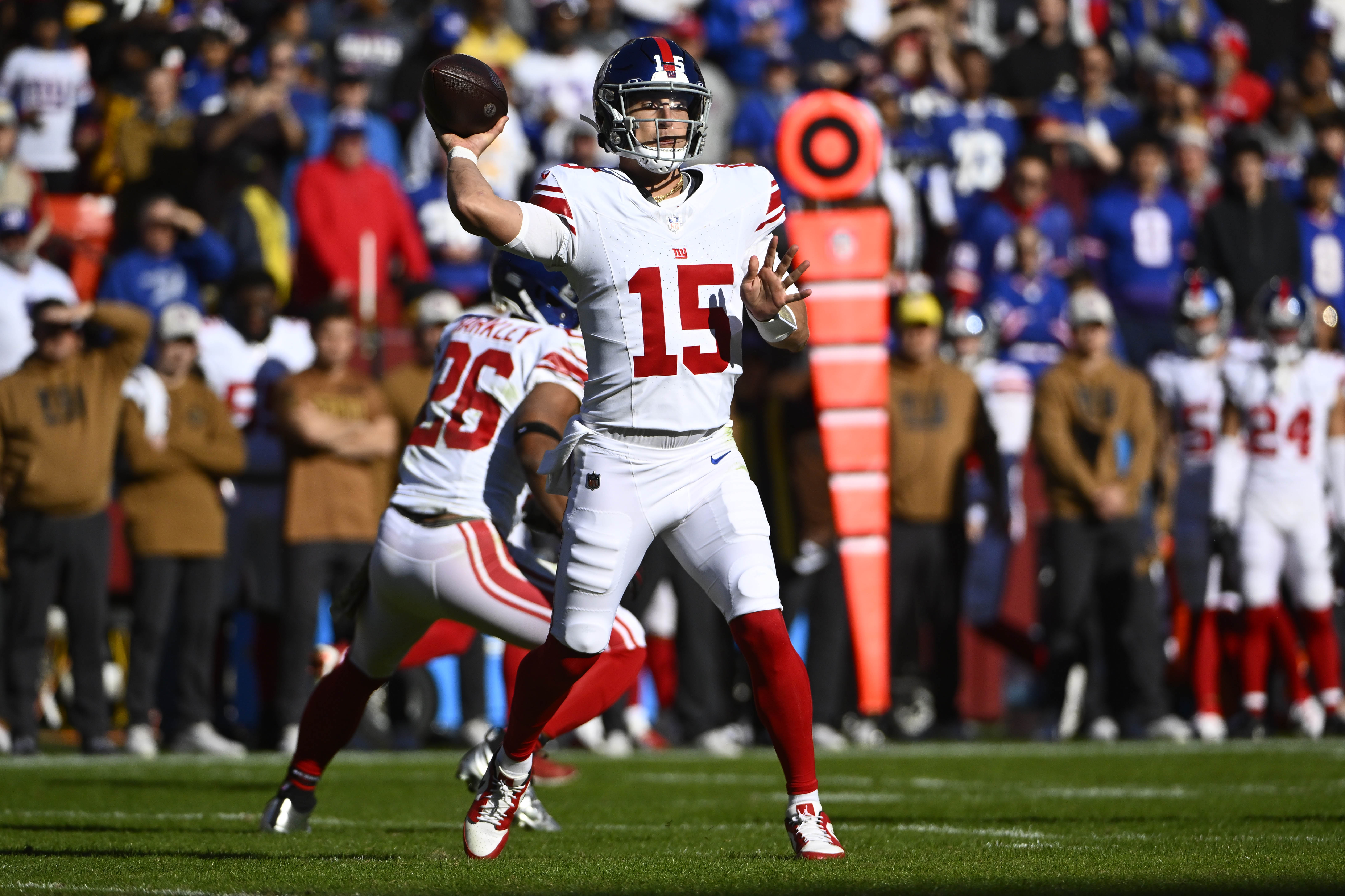 New York Giants quarterback Tommy DeVito (15) attempts a pass against the Washington Commanders during the first half at FedExField