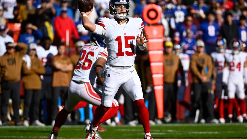 New York Giants quarterback Tommy DeVito (15) attempts a pass against the Washington Commanders during the first half at FedExField
