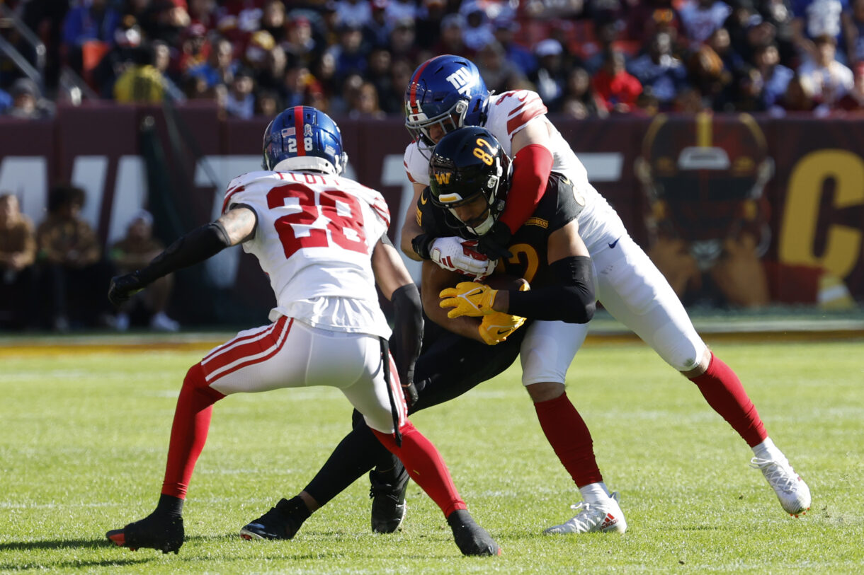 Washington Commanders tight end Logan Thomas (82) fumbles on a tackle by New York Giants linebacker Micah McFadden (41) and Giants cornerback Cor