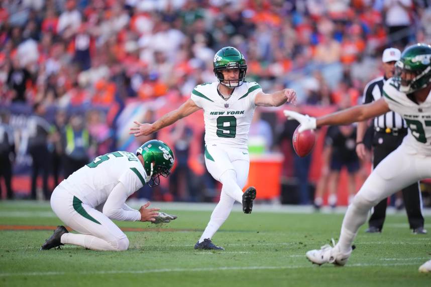 New York Jets place kicker Greg Zuerlein (9) kicks a field goal in the fourth quarter as punter Thomas Morstead (5) holds against the Denver Broncos at Empower Field at Mile High