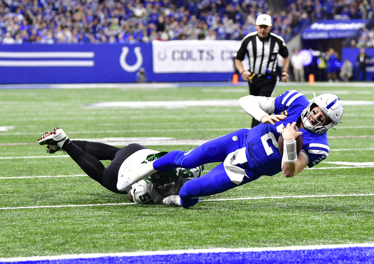 Indianapolis Colts quarterback Carson Wentz (2) is tackled short of the end zone by New York Jets defensive end Shaq Lawson (50) during the second half at Lucas Oil Stadium