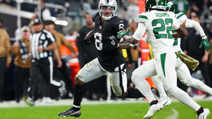 Las Vegas Raiders running back Josh Jacobs (8) runs ahead of New York Jets safety Tony Adams (22) during the third quarter at Allegiant Stadium