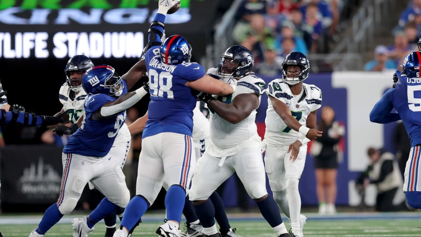 New York Giants defensive tackle D.J. Davidson (98) blocks a pass by Seattle Seahawks quarterback Geno Smith (7) during the second quarter at MetLife Stadium