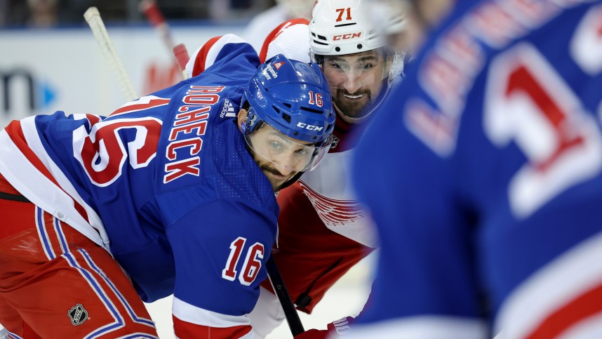 New York Rangers center Vincent Trocheck (16) and Detroit Red Wings center Dylan Larkin (71) fight for a face-off during the third period at Madison Square Garden