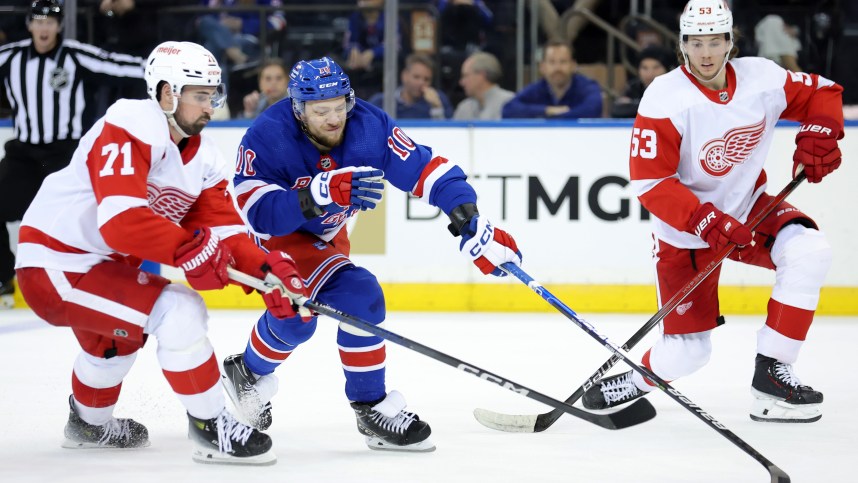 New York Rangers left wing Artemi Panarin (10) fights for the puck against Detroit Red Wings center Dylan Larkin (71) and defenseman Moritz Seider (53) during the third period at Madison Square Garden