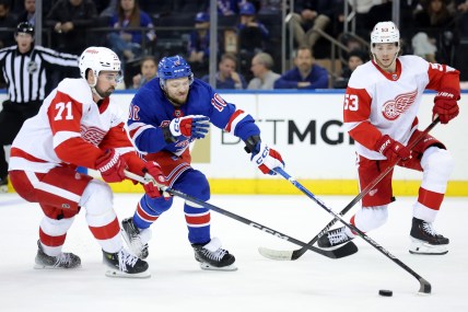 New York Rangers left wing Artemi Panarin (10) fights for the puck against Detroit Red Wings center Dylan Larkin (71) and defenseman Moritz Seider (53) during the third period at Madison Square Garden