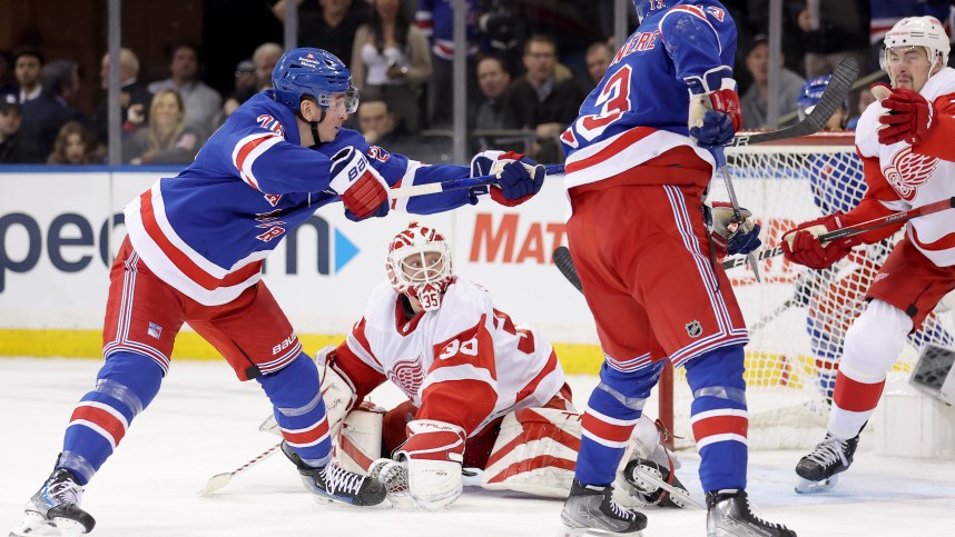 New York Rangers left wing Jimmy Vesey (26) scores the game winning goal against Detroit Red Wings goaltender Ville Husso (35) and defenseman Justin Holl (3) during the third period at Madison Square Garden