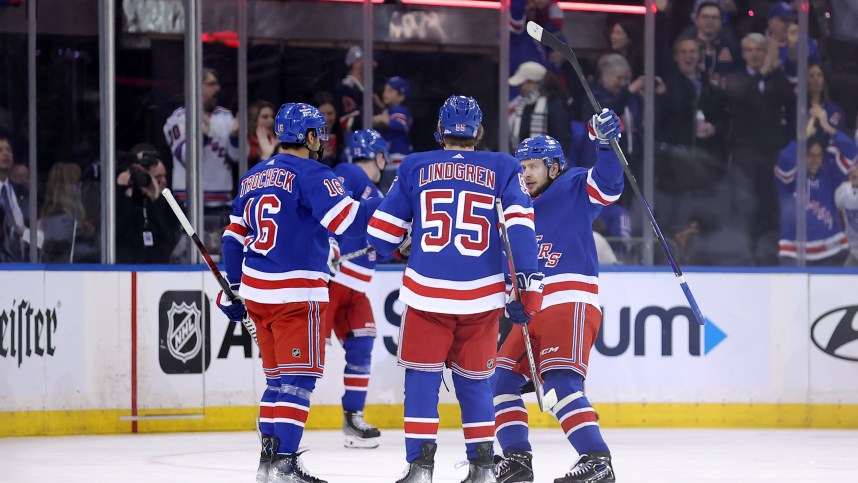 New York Rangers center Vincent Trocheck (16) celebrates his goal against the Minnesota Wild with defenseman Ryan Lindgren (55) and left wing Artemi Panarin (10) during the first period at Madison Square Garden