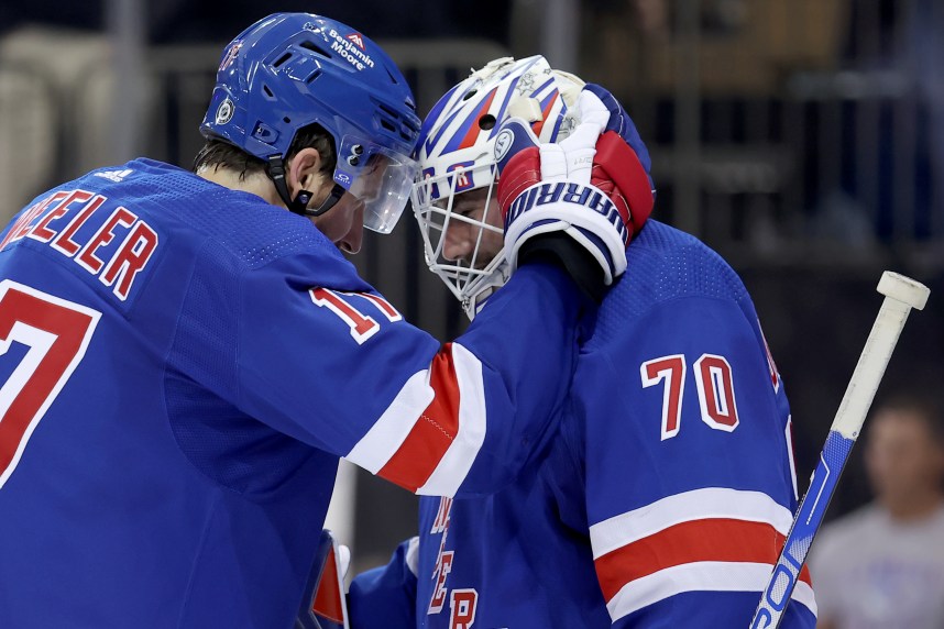 New York Rangers right wing Blake Wheeler (17) celebrates with goaltender Louis Domingue (70) after defeating the Minnesota Wild at Madison Square Garden
