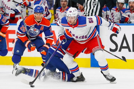 New York Rangers forward Will Cuylle (5) moves the puck around Edmonton Oilers forward Connor Brown (28) and defensemen Darnell Nurse (25) during the second period at Rogers Place