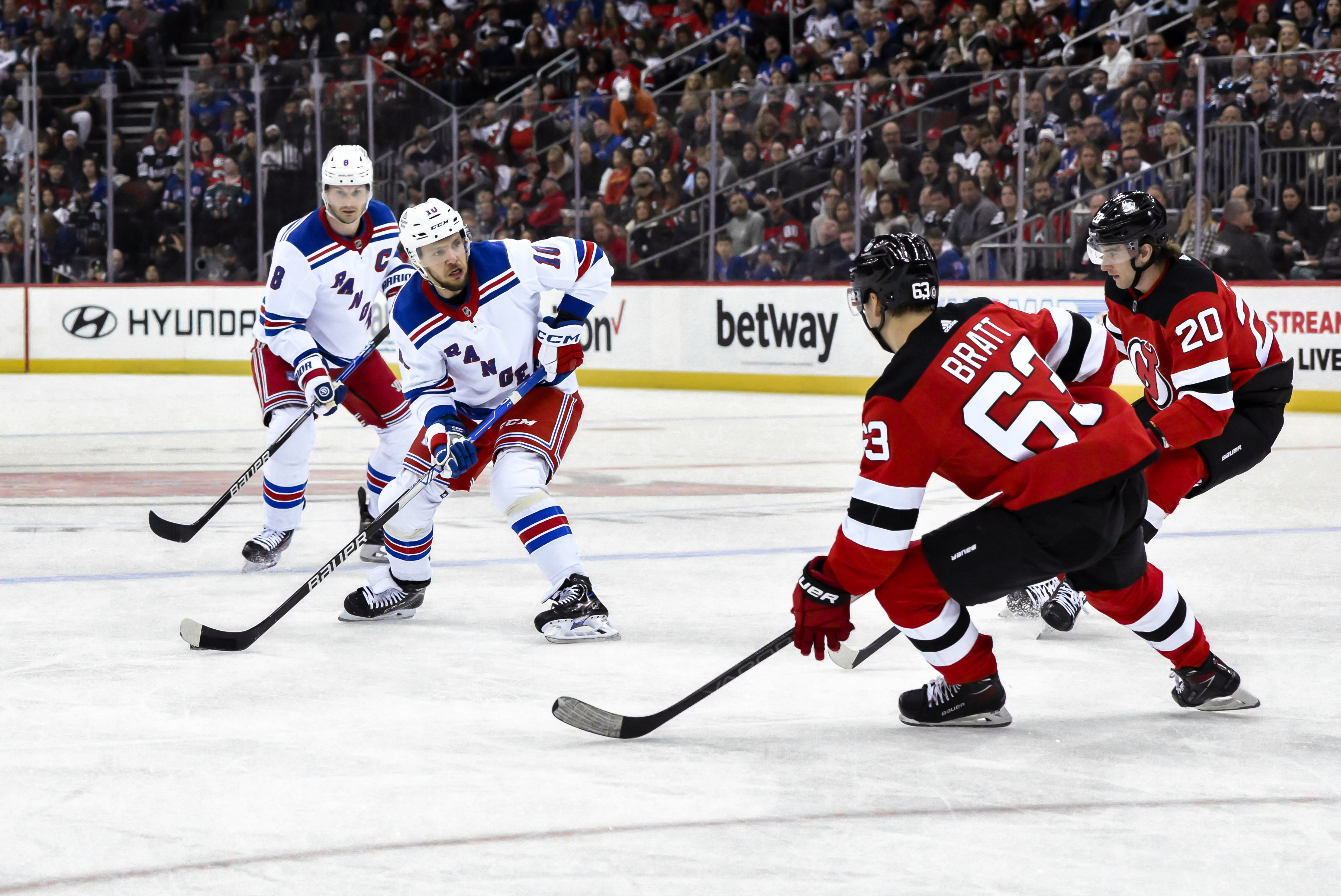 New York Rangers left wing Artemi Panarin (10) skates with the puck against New Jersey Devils left wing Jesper Bratt (63) and New Jersey Devils center Michael McLeod (20) during the first period at Prudential Center