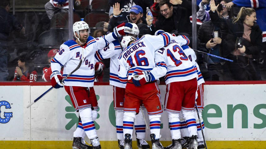 New York Rangers left wing Artemi Panarin (10) celebrates with teammates after scoring a goal against the New Jersey Devils during the third period at Prudential Center