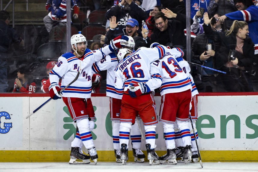 New York Rangers left wing Artemi Panarin (10) celebrates with teammates after scoring a goal against the New Jersey Devils during the third period at Prudential Center
