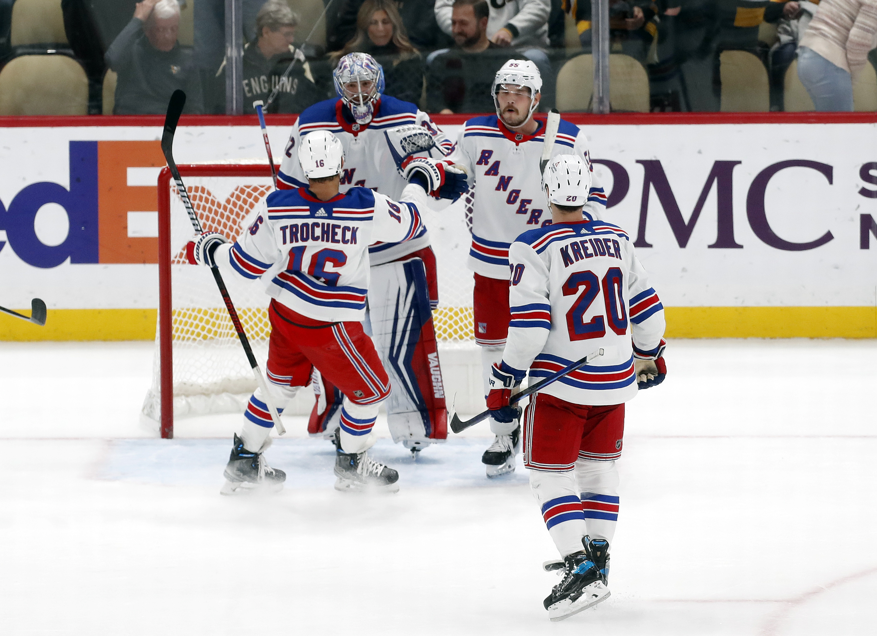 New York Rangers center Vincent Trocheck (16) and goaltender Jonathan Quick (32) and left wing Chris Kreider (20) and defenseman Ryan Lindgren (55) celebrate after defeating the Pittsburgh Penguins at PPG Paints Arena