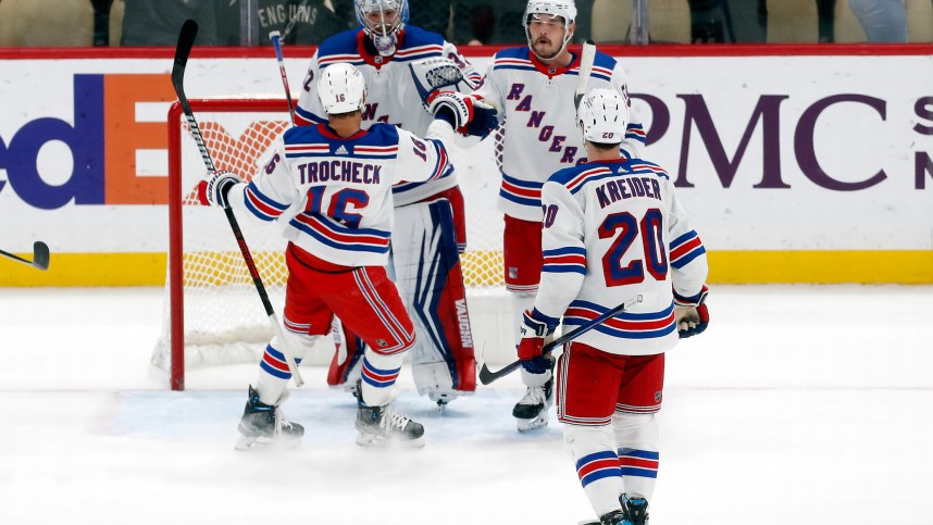New York Rangers center Vincent Trocheck (16) and goaltender Jonathan Quick (32) and left wing Chris Kreider (20) and defenseman Ryan Lindgren (55) celebrate after defeating the Pittsburgh Penguins at PPG Paints Arena
