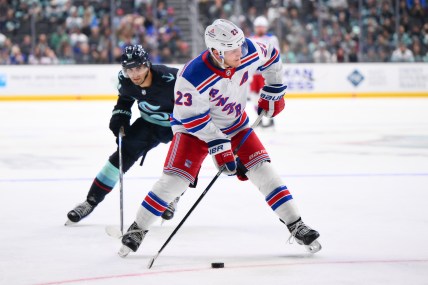 New York Rangers defenseman Adam Fox (23) plays the puck during the third period against the New York Rangers at Climate Pledge Arena
