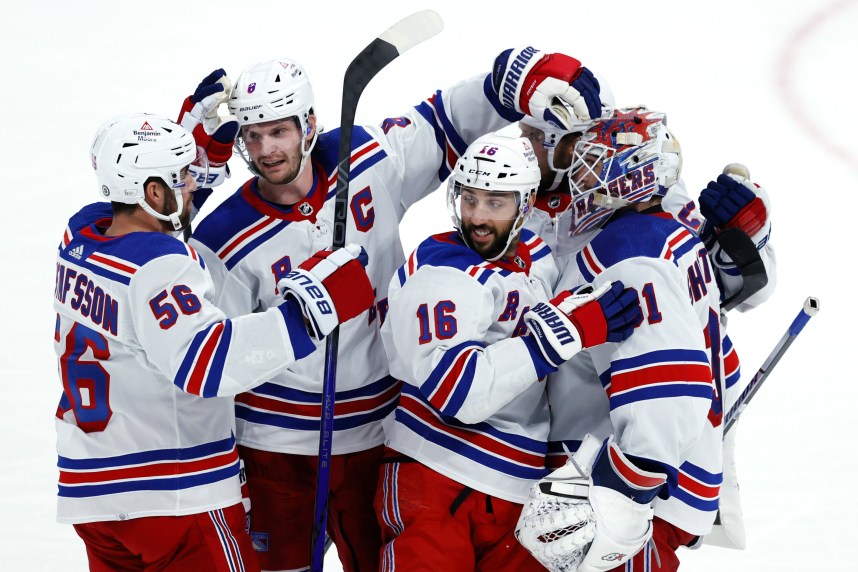 New York Rangers players celebrate their overtime win against the Winnipeg Jets at Canada Life Centre