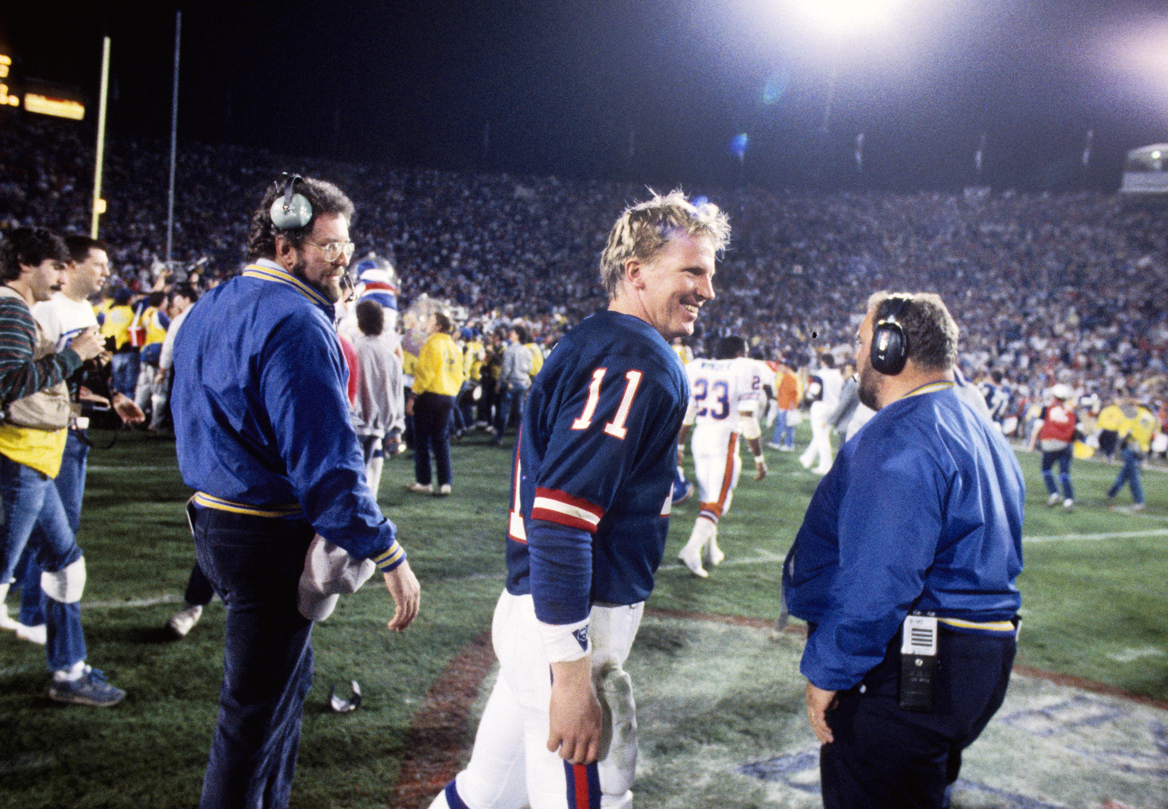 New York Giants quarterback Phil Simms (11) celebrates after defeating the Denver Broncos in Super Bowl XXI at the Rose Bowl. The Giants defeated the Broncos 39-20