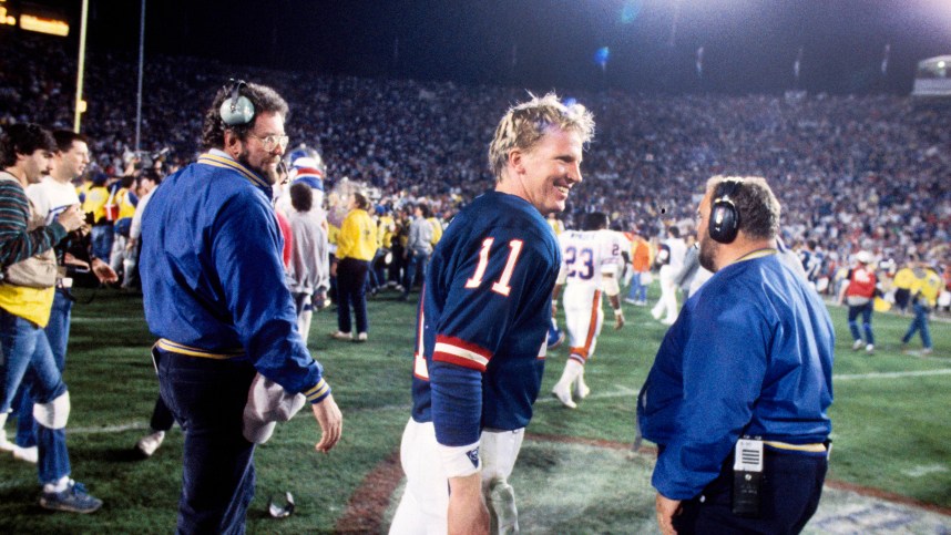 New York Giants quarterback Phil Simms (11) celebrates after defeating the Denver Broncos in Super Bowl XXI at the Rose Bowl. The Giants defeated the Broncos 39-20