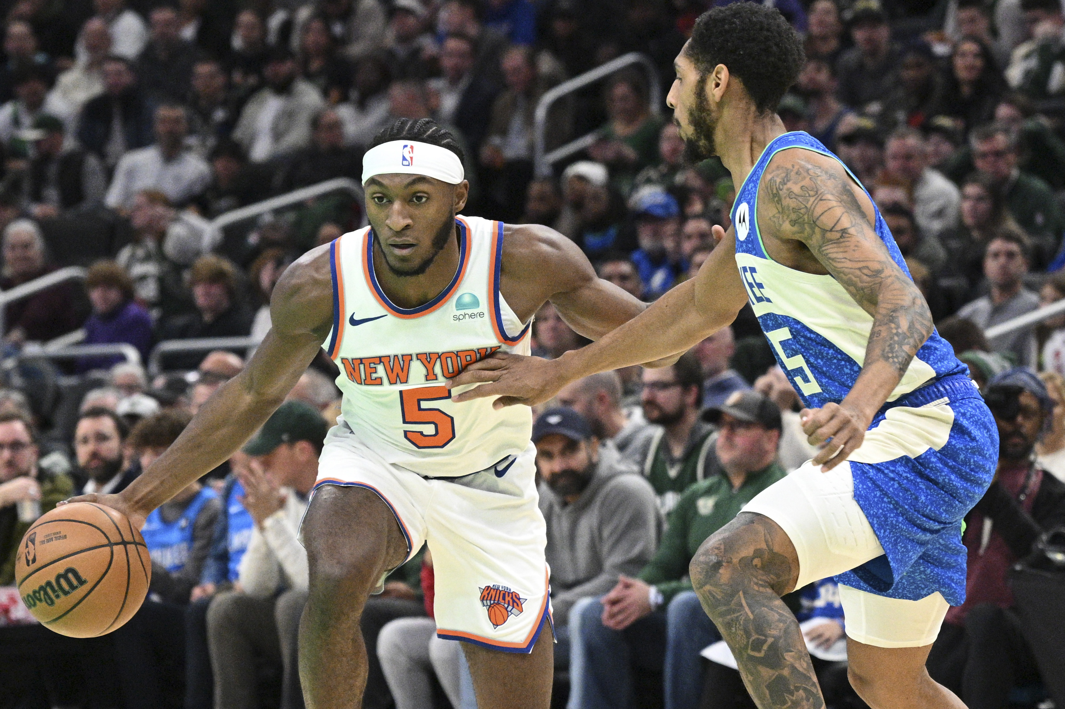 New York Knicks guard Immanuel Quickley (5) drives to the basket against Milwaukee Bucks guard Cameron Payne (15) in the first half at Fiserv Forum