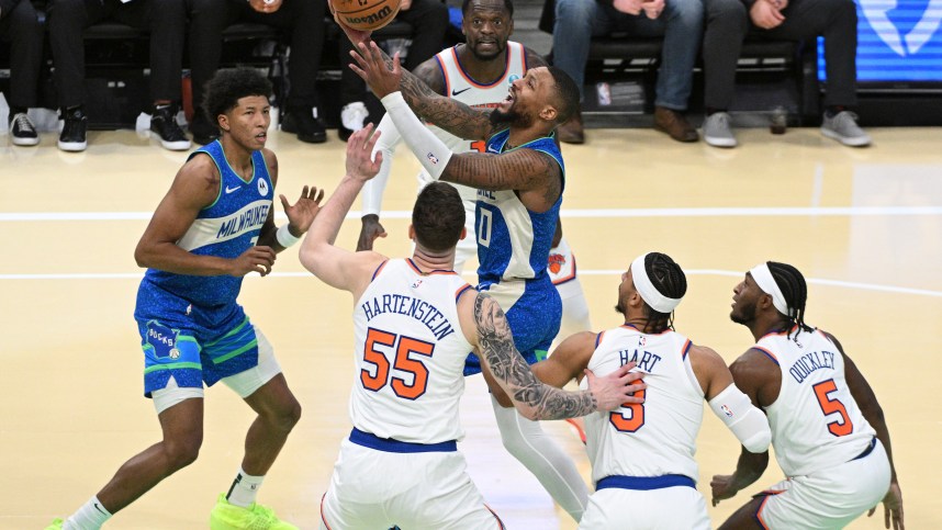 Milwaukee Bucks guard Damian Lillard (0) drives to the basket against New York Knicks defenders in the second half at Fiserv Forum