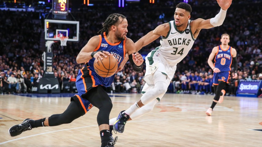 New York Knicks guard Jalen Brunson (11) looks to drive past Milwaukee Bucks forward Giannis Antetokounmpo (34) in the second quarter at Madison Square Gar