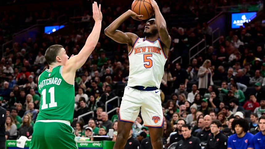 New York Knicks guard Immanuel Quickley (5) shoots over Boston Celtics guard Payton Pritchard (11) during the first half at TD Garden