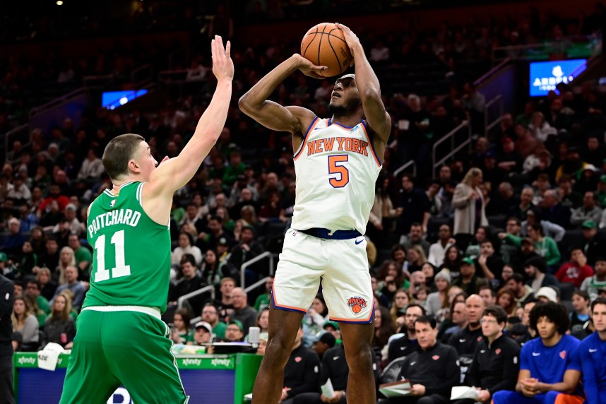 New York Knicks guard Immanuel Quickley (5) shoots over Boston Celtics guard Payton Pritchard (11) during the first half at TD Garden