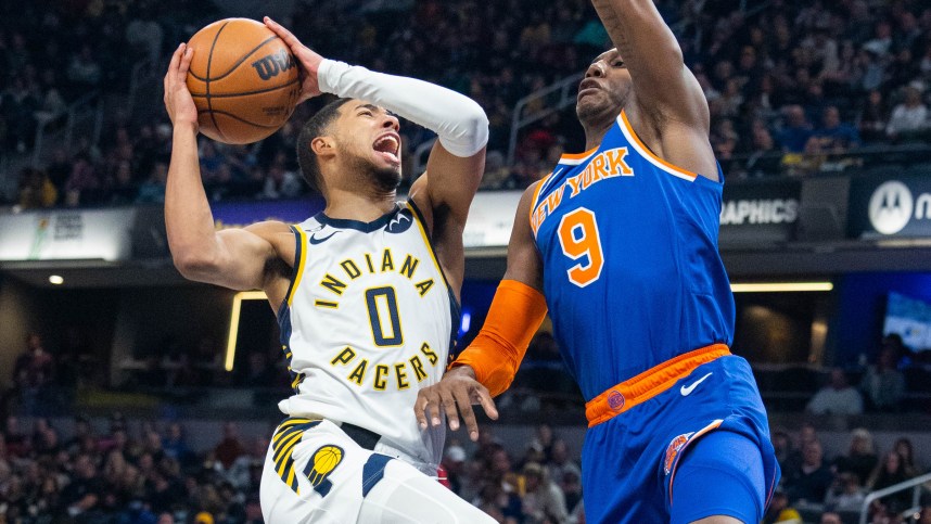 Indiana Pacers guard Tyrese Haliburton (0) shoots the ball while New York Knicks guard RJ Barrett (9) defends in the second half at Gainbridge Fieldhouse