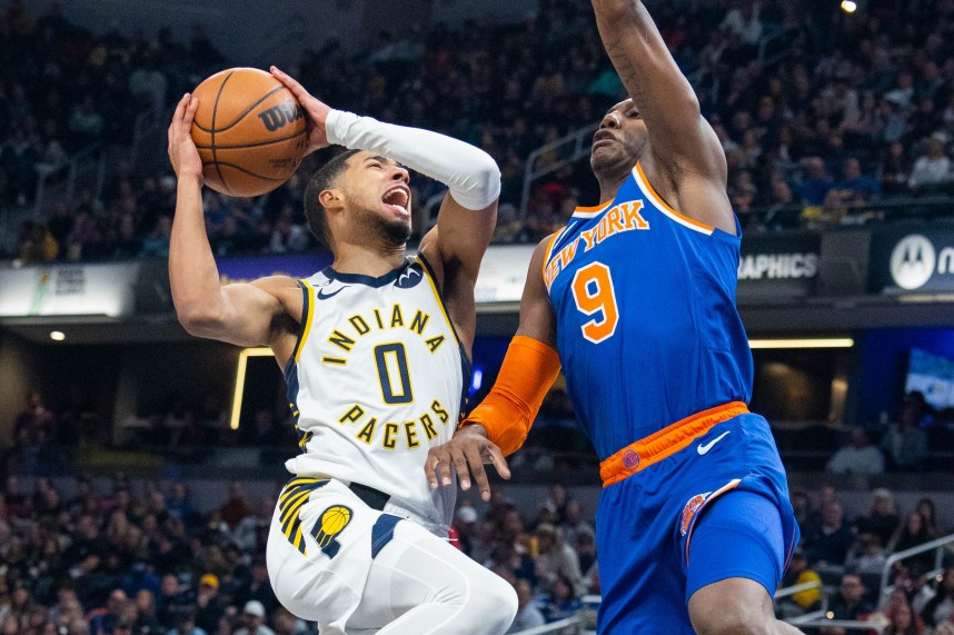 Indiana Pacers guard Tyrese Haliburton (0) shoots the ball while New York Knicks guard RJ Barrett (9) defends in the second half at Gainbridge Fieldhouse