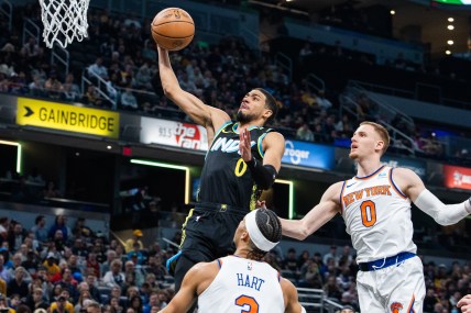 Indiana Pacers guard Tyrese Haliburton (0) shoots the ball while New York Knicks guard Donte DiVincenzo (0) defends in the first quarter at Gainbridge Fieldhouse