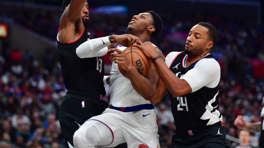 Los Angeles Clippers forward Paul George (13) and guard Norman Powell (24) defend against New York Knicks guard RJ Barrett (9) during the second half at Crypto.com Arena